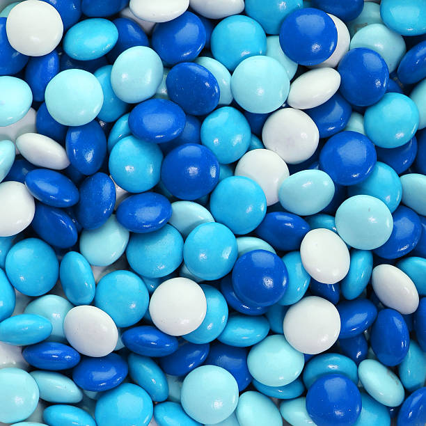 Chocolate Candy Coated In Blue Background Stock Photo - Download