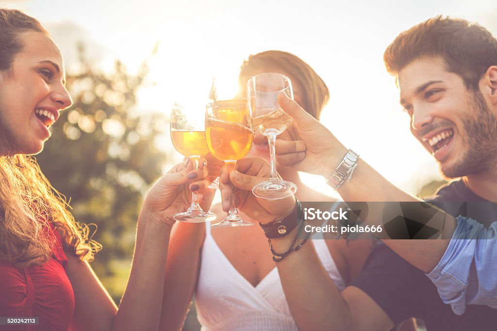 Group of friends drinking wine in cheerful moment Aperitif Stock Photo