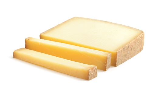 French Comte cheese isolated on a white background.