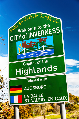 Inverness, United Kingdom - October 19, 2014: Sign at the entrance to the city of Inverness in Northern Scotland. Inverness is one of the fastest growing cities in Western Europe and is the cultural capital of the Highland Region of Scotland. With its easy access to some outstanding scenery, Inverness often comes out top of the list of the happiest places to live.