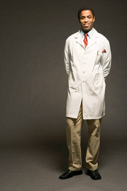 Male physician on black background, portrait