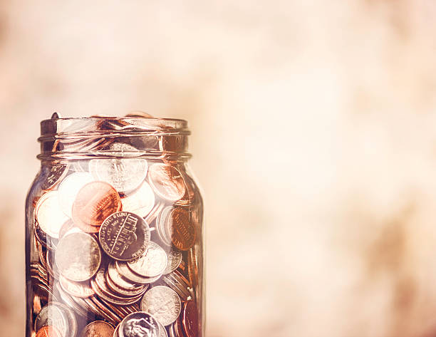 istock Donation jar overflowing with money 520259773