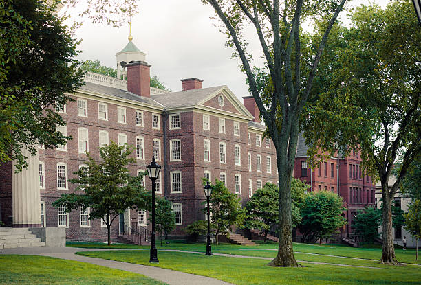Buildings along Front Green at Brown University campus in Providence Providence, United States - August 9, 2014: A man is seen walking along the Front Green near University Hall and Slater Hall during the evening time on the campus of Brown University. Brown University, a private Ivy League university that was founded in 1764, is the 7th oldest institution of higher learning in the United States and currently has over 8,000 enrolled students. brown university stock pictures, royalty-free photos & images