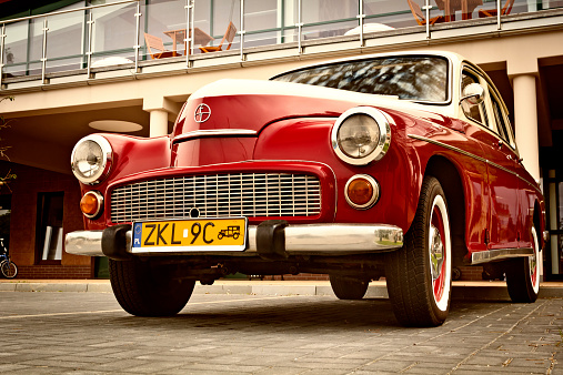 Kolobrzeg, Poland - July 05, 2012: Renovated old polish red and white car Warszawa 223 in the parking lot in the city center. Warszawa is a Polish automobile marque manufactured from 1951 to 1973 by the FSO of Warsaw