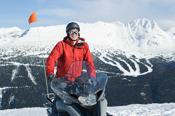 istock Snow patrol rescue worker sitting on snowmobile 520260521