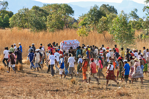 Isalo, Madagascar - September 9, 2013: A big crowd joins a local traditional Malagasy funeral procession in Isalo, Madagascar, on September 9, 2013