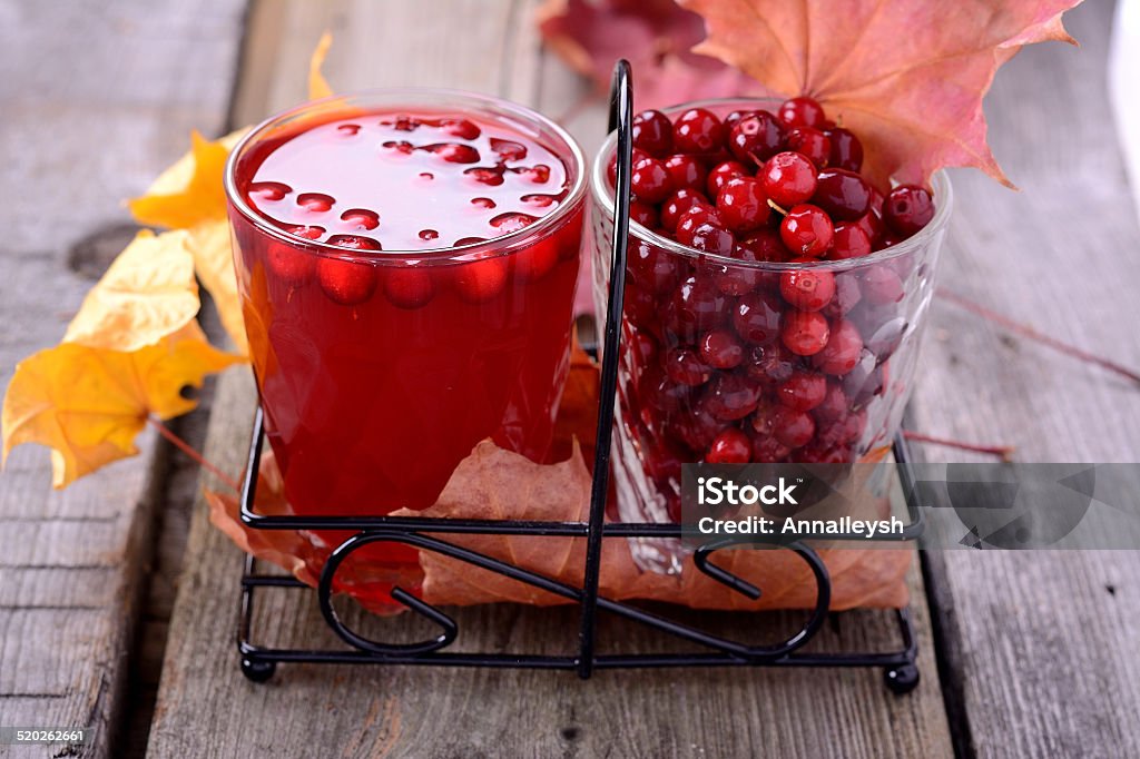 lingonberry juice and berries lingonberry juice and berries on old wooden table Berry Fruit Stock Photo