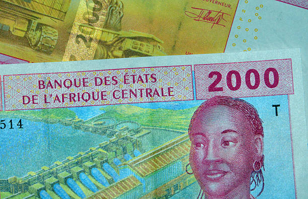 Central African CFA Francs (XAF currency code) Brazzaville, Congo: partial view of Central African CFA Franc bank notes issued by the BEAC (Banque des États de l'Afrique Centrale, Bank of the Central African States) - currency of the Economic and Monetary Community of Central Africa (Cameroon, Central African Republic, Chad, Republic of the Congo, Equatorial Guinea and Gabon) - 2000 Francs obverse and reverse - woman and mining truck-  photo by M.Torres chad central africa stock pictures, royalty-free photos & images