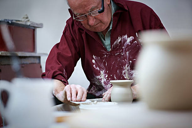 istock Senior male potter working 520265715