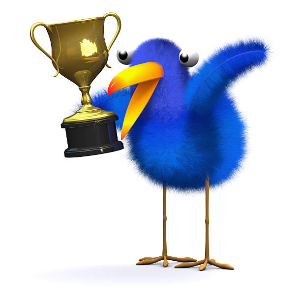 istock 3d Bluebird with a gold trophy 520278217