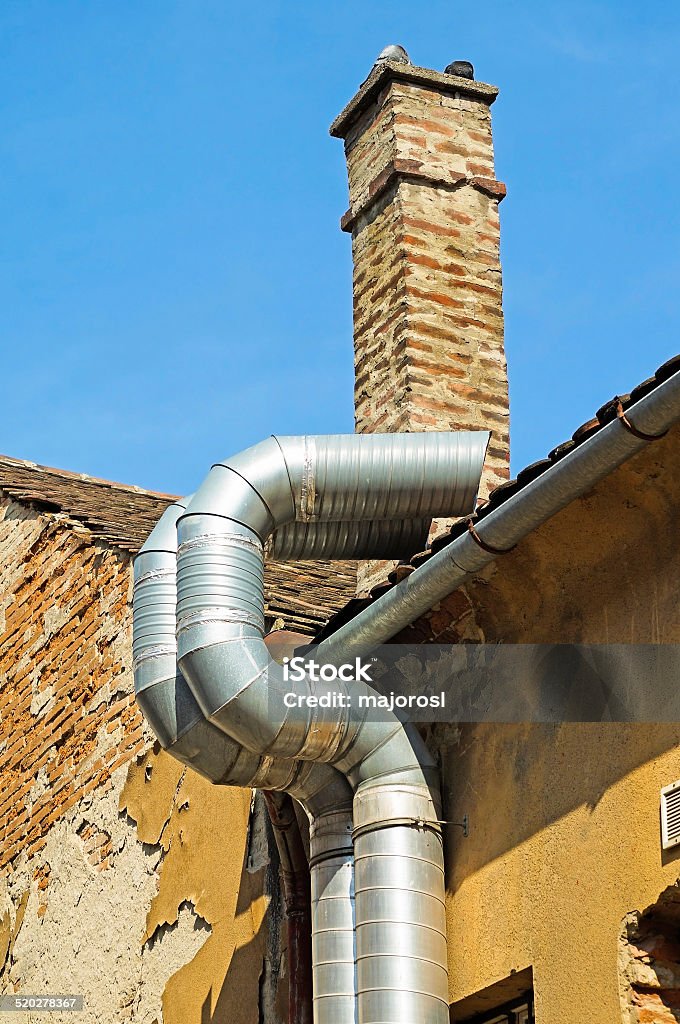 Steel pipes Steel pipes next to an old ruined industrial building Architecture Stock Photo