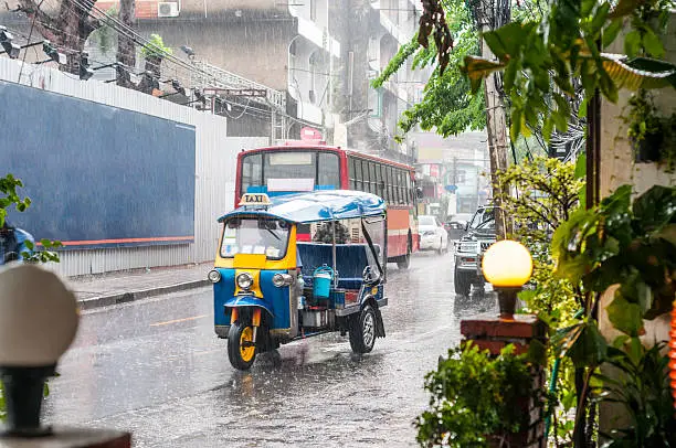 A Speeding Tuk Tuk In The Rain In Bangkok, Thailand