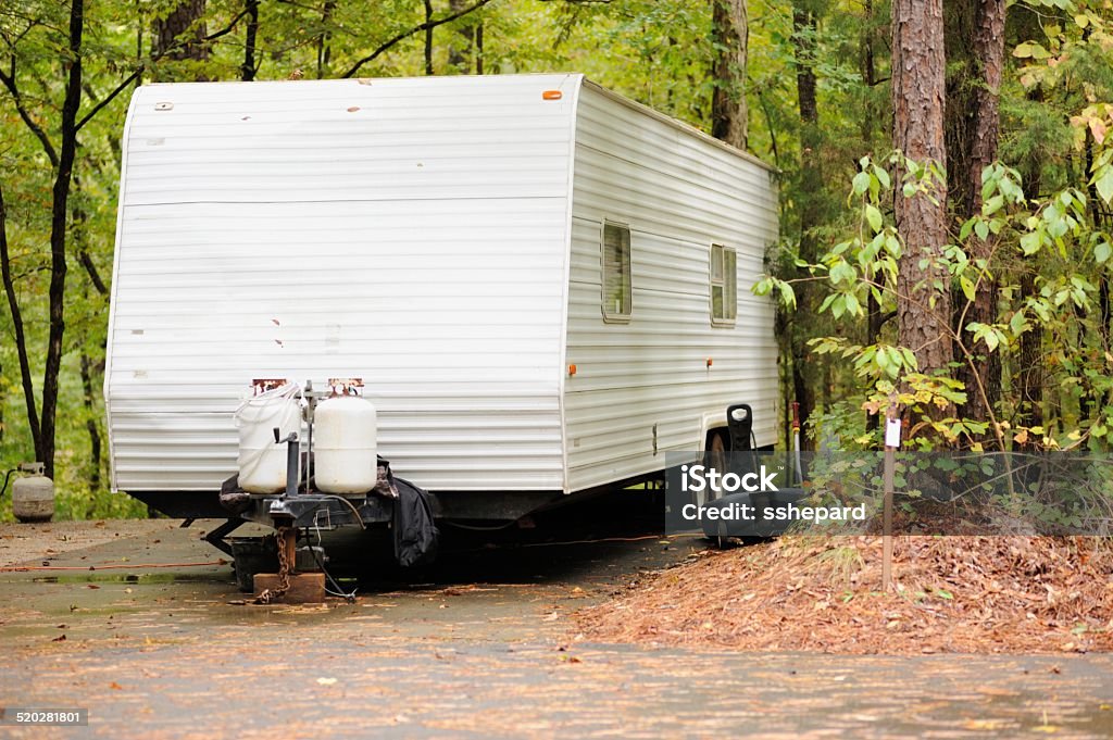 Recreational vehicle travel trailer in campsite Generic recreational vehicle travel trailer in campsite. Camping Stock Photo