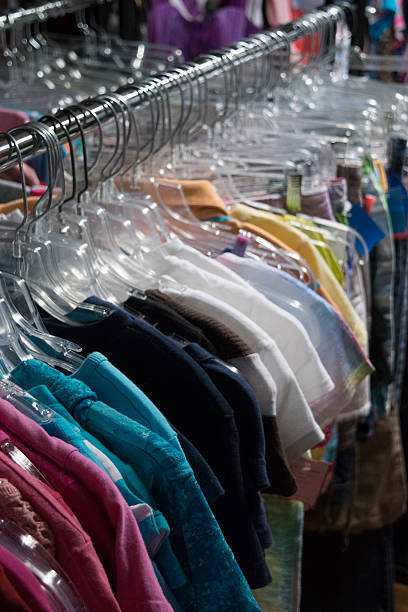 istock Clothing hanging on a rack in a store 520283692