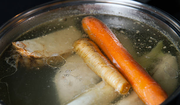 istock Cooking base of chicken soup, bouillon in pot 520284430