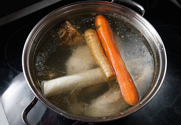 istock Cooking base of chicken soup, bouillon in pot 520284642
