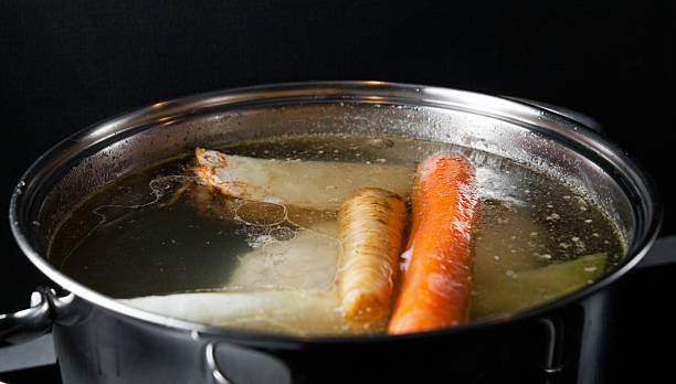istock Cooking base of chicken soup, bouillon in pot 520284702