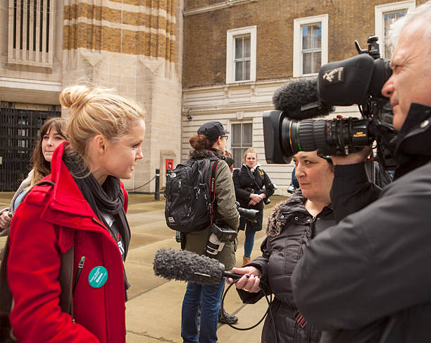 The Fourth Junior Doctors' Strike.  London, United Kingdom - April 6, 2016: Lauren Gavaghan, one of the main organisers of the rally outside the Department of Health in support of the fourth Junior Doctors' Strike, is being interviewed by journalists from the BBC. bbc photos stock pictures, royalty-free photos & images