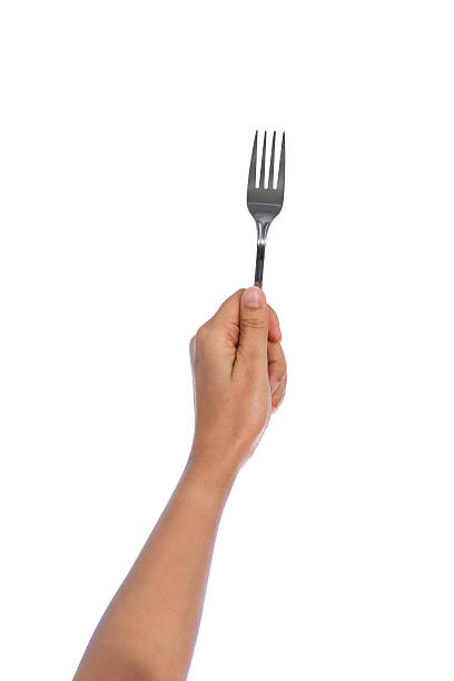 istock Woman hand holding a silver fork  isolated on white 520285806