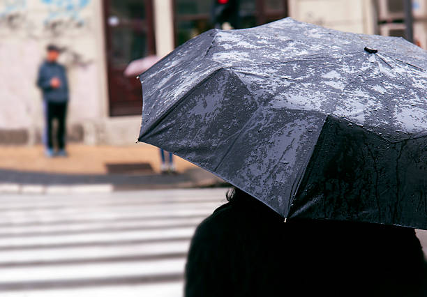 istock Woman with umbrella on rainy day 520286248