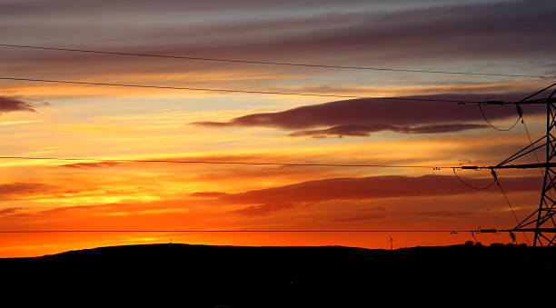 istock Sunset orange purple dramatic sky Pylon on Pennines silhouette 520288014