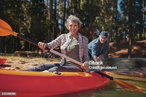 Happy Senior Woman In A Kayak At The Lake Stock Photo - Download Image Now - Kayak, Senior Adult, Kayaking