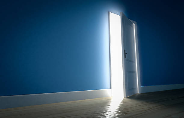 istock Light shining through open door in dark room 520288648