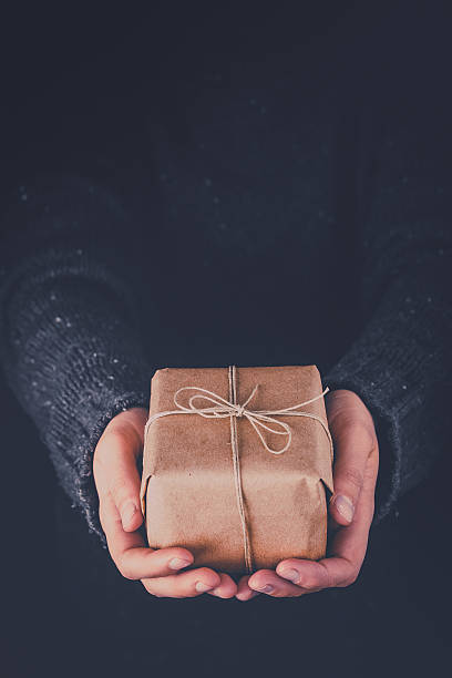 istock Woman hands holding gift 520289920