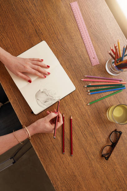 istock Woman hands making a flower sketch on sketchbook 520290436
