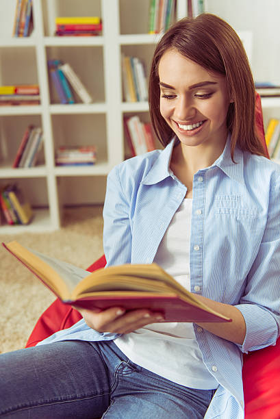 istock Girl reading at home 520292404