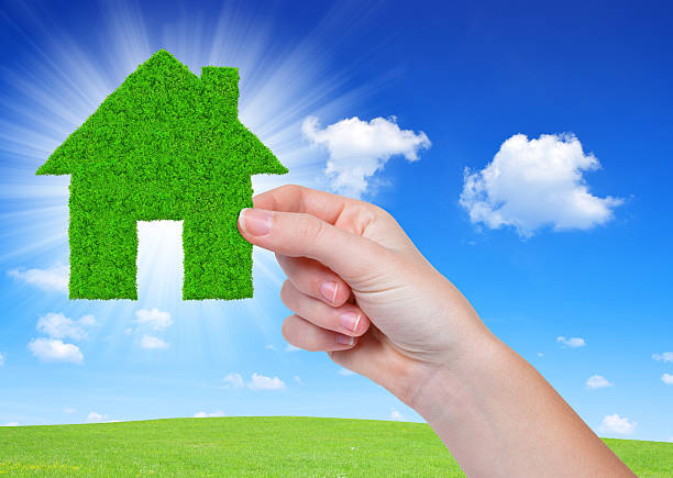 istock green house in hands 520293233