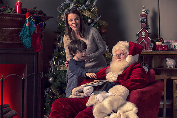 istock Mom and son sneaking up on sleeping Santa 520294239