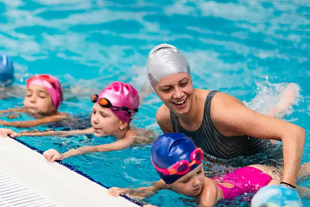 Swimming school - Swimming instructor with children