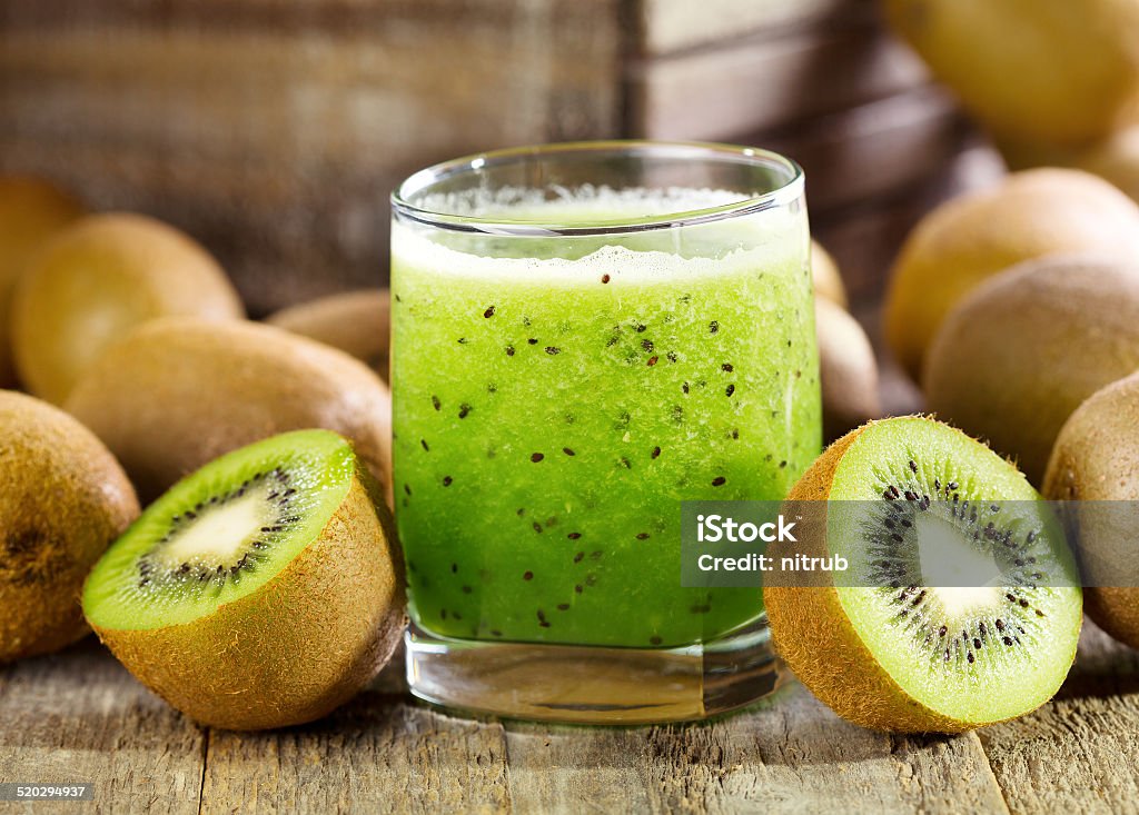 glass of kiwi juice with fresh fruits glass of kiwi juice with fresh fruits on wooden table Kiwi Fruit Stock Photo