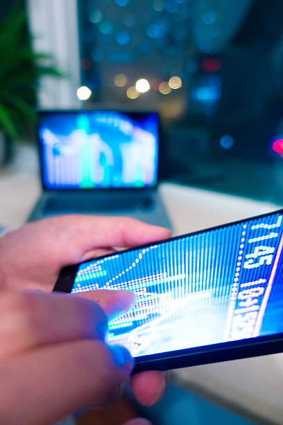 istock Smartphone and laptop with stock market graph 520295566