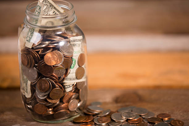 istock Money jar with U.S. currency.  Savings, donations concepts. 520295915