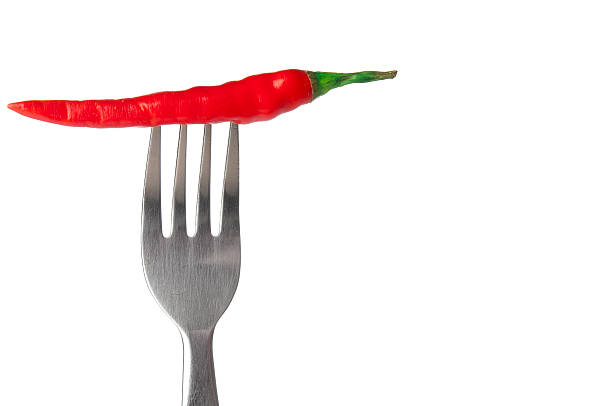 istock Red hot chili pepper impaled on steel fork 520296469