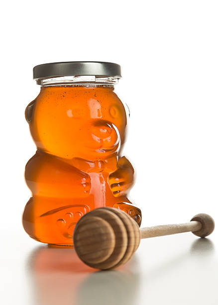 istock Honey Bear (jar) with Honey Dipper Aside, Isolated on White. 520296489