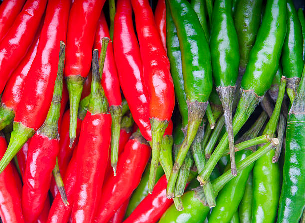 istock Red and green hot peppers as background 520296775