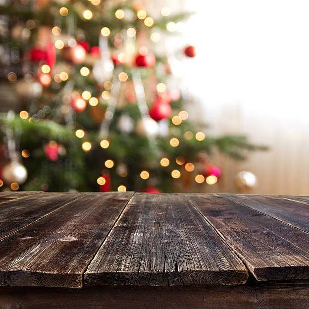 table against christmas tree stock photo