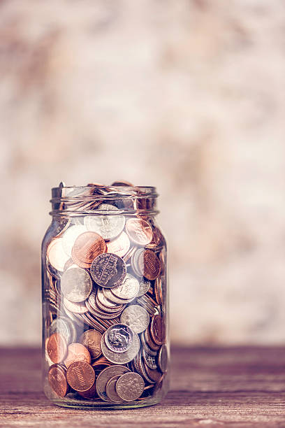 istock Donation jar overflowing with money 520297823