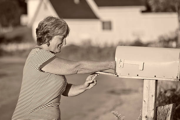 istock Woman Checks Her Mailbox for Mail 520299063