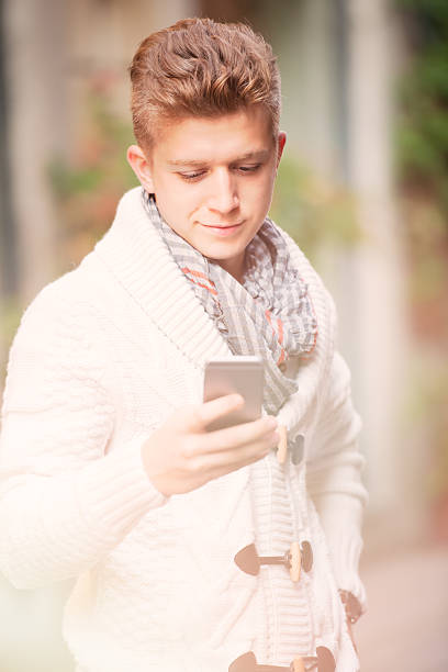 istock Young blond man messaging on smart phone 520299863