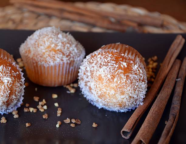 istock Three homemade muffins with grated coconut 520320848