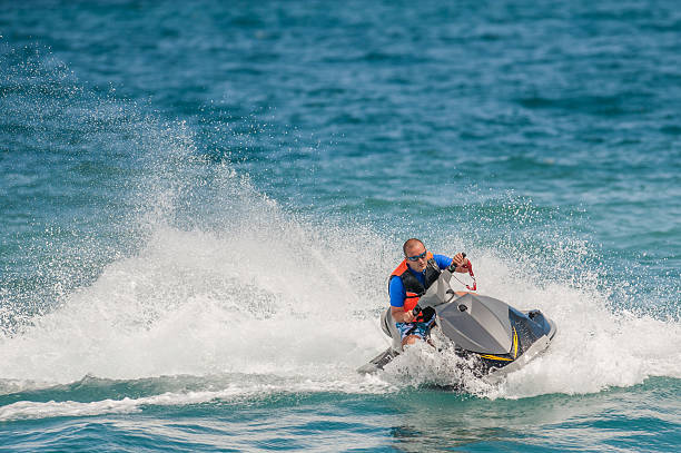 istock Young Man on Jet Ski, Tropical Ocean, Vacation Concept 520321454