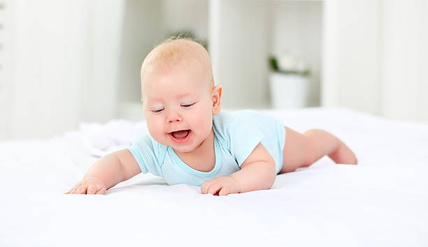 istock happy newborn baby on bed 520321894