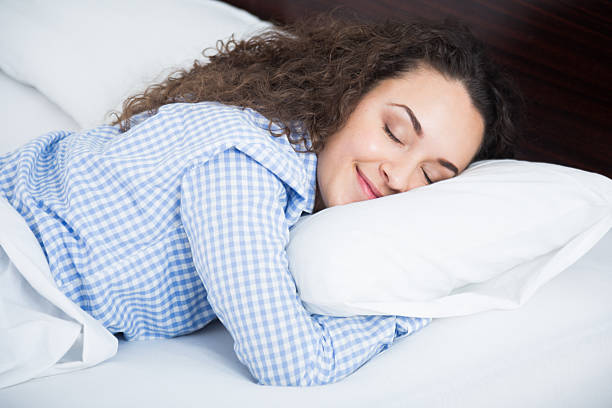 istock Curly haired girl having a nap in bed 520322824