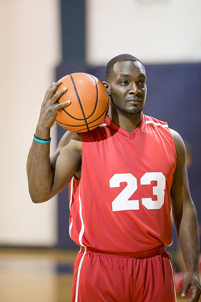 istock Collegiate basketball player posing with basketball 520323374