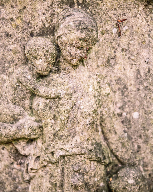 Stone monument of Saint Anthony from Padua holds a child Jesus in Pidhirtsi, Lviv region, Ukraine.