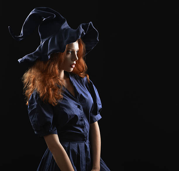 istock beautiful red-haired girl in a  costume witch 520324467
